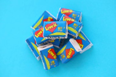 TERNOPIL, UKRAINE - JUNE 23, 2022: Love is - turkish bubble gums from 1990s popular in russian region. Various flavors of Love is chewing gum with liners about love in pile