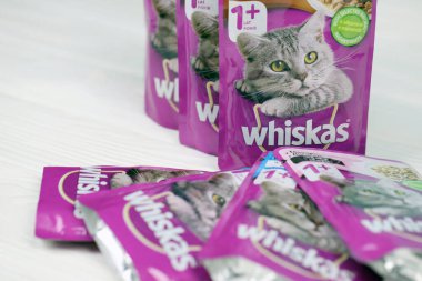 KHARKIV, UKRAINE - FEBRUARY 06, 2021: Whiskas branded cat pet food purple packages close up. Whiskas is a global brand of cat food produced by the American company Mars, Inc