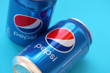 TERNOPIL, UKRAINE - MAY 28, 2022: Cold Pepsi drink cans. Pepsi is a carbonated soft drink produced by PepsiCo since 1893
