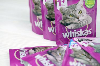 KHARKIV, UKRAINE - FEBRUARY 06, 2021: Whiskas branded cat pet food purple packages close up. Whiskas is a global brand of cat food produced by the American company Mars, Inc