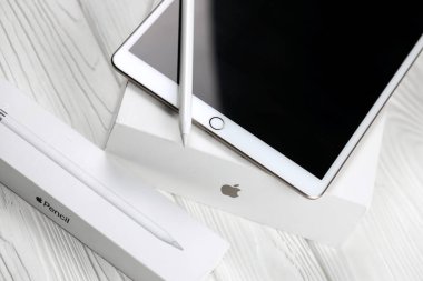 KHARKIV, UKRAINE - JANUARY 27, 2021: Brand new Apple iPad and Apple Pencil on white background. Apple Inc. is an American technology company headquartered in California