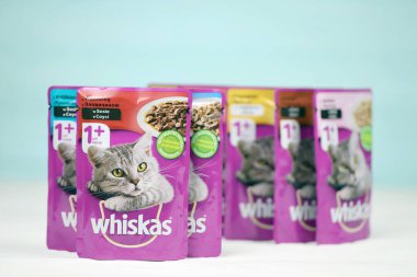 KHARKIV, UKRAINE - FEBRUARY 06, 2021: Whiskas branded cat pet food purple packages close up. Whiskas is a global brand of cat food produced by the American company Mars, Inc