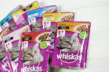 KHARKIV, UKRAINE - FEBRUARY 06, 2021: Whiskas branded cat pet food purple packages close up. Whiskas is a global brand of cat food produced by the American company Mars, Inc