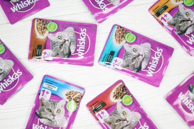 KHARKIV, UKRAINE - FEBRUARY 06, 2021: Whiskas branded cat pet food purple packages close up. Whiskas is a global brand of cat food produced by the American company Mars, Inc