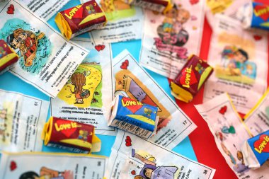 TERNOPIL, UKRAINE - JUNE 23, 2022: Love is - turkish bubble gum from 1990s popular in russian region. Various flavors of Love is chewing gum with liners about love in pile