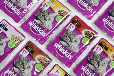 KHARKIV, UKRAINE - FEBRUARY 06, 2021: Whiskas branded cat pet food purple packages close up. Whiskas is a global brand of cat food produced by the American company Mars, Inc