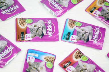 KHARKIV, UKRAINE - FEBRUARY 06, 2021: Whiskas branded cat pet food purple packages close up. Whiskas is a global brand of cat food produced by the American company Mars, Inc