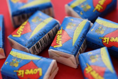 TERNOPIL, UKRAINE - JUNE 23, 2022: Love is - turkish bubble gums from 1990s popular in russian region. Various flavors of Love is chewing gum with liners about love in pile