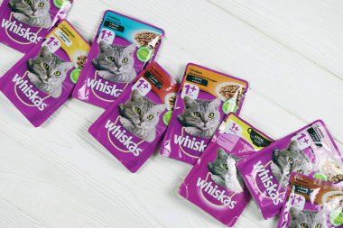 KHARKIV, UKRAINE - FEBRUARY 06, 2021: Whiskas branded cat pet food purple packages close up. Whiskas is a global brand of cat food produced by the American company Mars, Inc