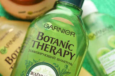 TERNOPIL, UKRAINE - SEPTEMBER 2, 2022 Bottle of Garnier Botanic Therapy Green Tea Shampoo among another Garnier company products close up