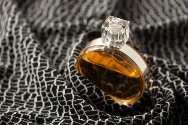 TERNOPIL, UKRAINE - SEPTEMBER 2, 2022 Chanel Chance worldwide famous french perfume bottle on monochrome plaid fabric