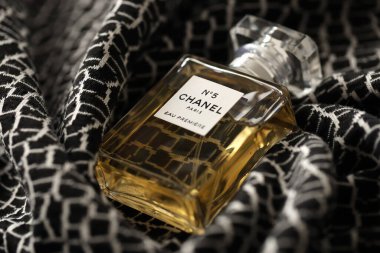 TERNOPIL, UKRAINE - SEPTEMBER 2, 2022 Chanel Number 5 Eau Premiere worldwide famous french perfume bottle on monochrome plaid fabric