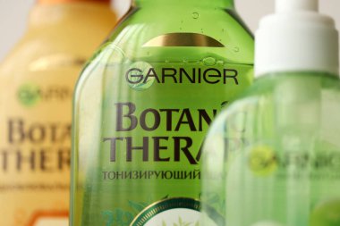 TERNOPIL, UKRAINE - SEPTEMBER 2, 2022 Bottle of Garnier Botanic Therapy Green Tea Shampoo among another Garnier company products close up