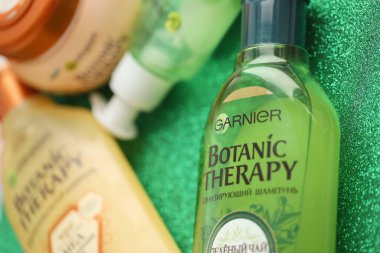 TERNOPIL, UKRAINE - SEPTEMBER 2, 2022 Bottle of Garnier Botanic Therapy Green Tea Shampoo among another Garnier company products close up