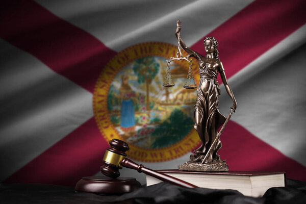 Florida US state flag with statue of lady justice, constitution and judge hammer on black drapery. Concept of judgement and punishment