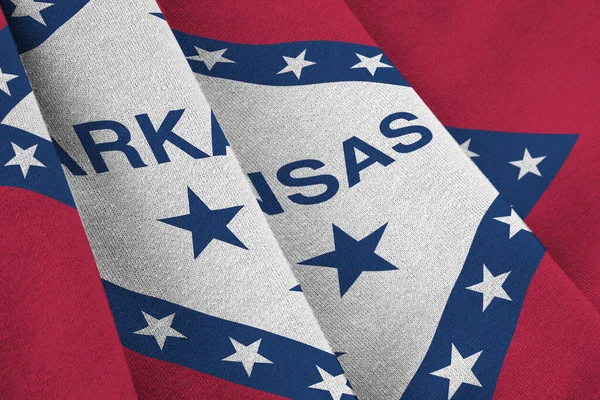 Arkansas US state flag with big folds waving close up under the studio light indoors. The official symbols and colors in fabric banner