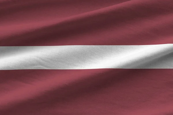Łotwa Flaga Dużymi Fałdami Macha Bliska Pod Światło Studio Wewnątrz — Zdjęcie stockowe