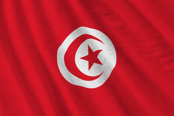 在室内的演播室灯光下 巨大的褶皱摇曳着突尼斯国旗 织物横幅中的官方符号和颜色 — 图库照片