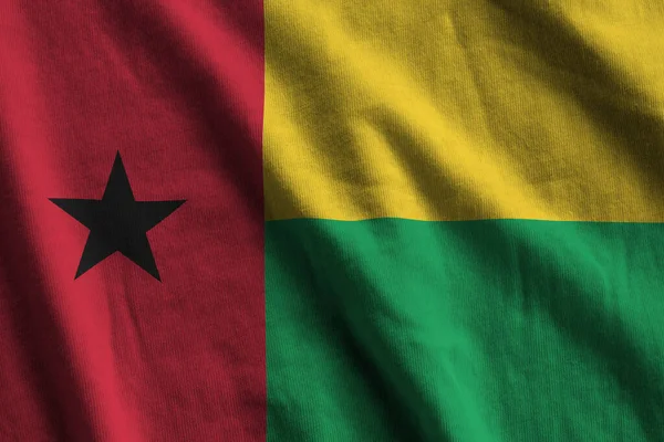 Guinea Bissau Vlajka Velkými Záhyby Mávající Zblízka Pod Studiovým Světlem — Stock fotografie