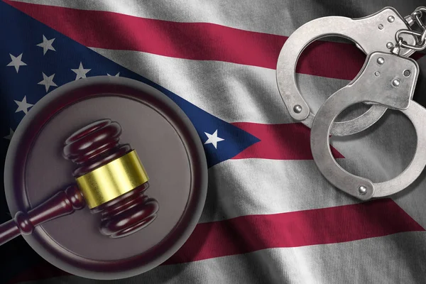 Ohio US state flag with judge mallet and handcuffs in dark room. Concept of criminal and punishment, background for guilty topics