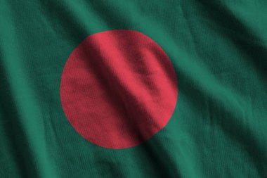 Bangladeş bayrağı, büyük kıvrımlı stüdyo ışıklarının altında sallanıyor. Resmi semboller ve renkler kumaş pankartıyla