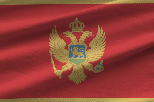 Bandeira Montenegro Com Grandes Dobras Acenando Perto Sob Luz Estúdio — Fotografia de Stock