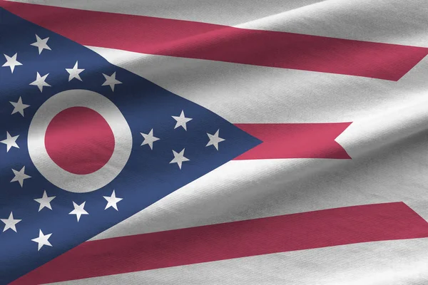 Ohio US state flag with big folds waving close up under the studio light indoors. The official symbols and colors in fabric banner
