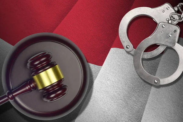 Indonesia flag with judge mallet and handcuffs in dark room. Concept of criminal and punishment, background for guilty topics