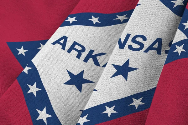 Arkansas US state flag with big folds waving close up under the studio light indoors. The official symbols and colors in fabric banner