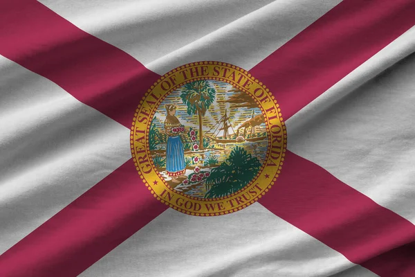 Florida US state flag with big folds waving close up under the studio light indoors. The official symbols and colors in fabric banner