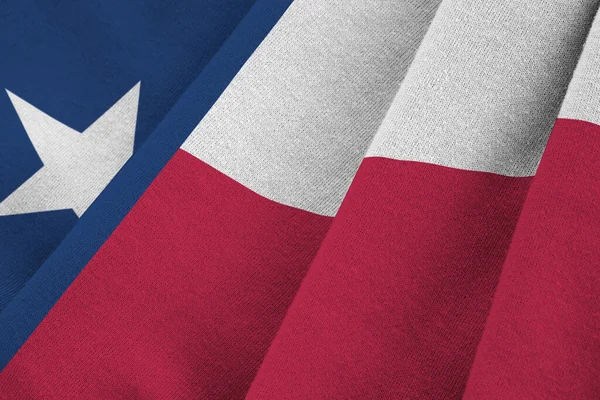 Texas US state flag with big folds waving close up under the studio light indoors. The official symbols and colors in fabric banner