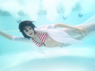 Pool-beautiful woman portrait underwater with sunglasses
