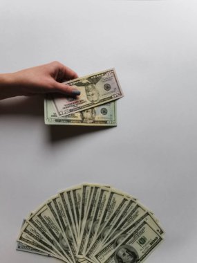 Beyaz arka plandaki bir kızın ellerinde Amerikan doları.