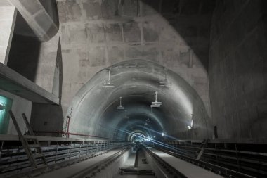 Underground facility with a big tunnel leading deep down. Metro - subway construction site. High quality photo