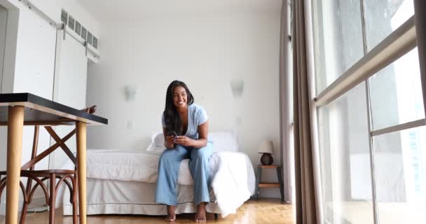 Joven Mujer Negra Trabajando Casa Con Smartphone Sentado Cama Dormitorio — Vídeos de Stock