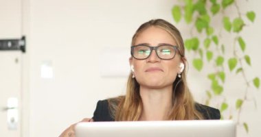 Evinde dizüstü bilgisayarıyla çalışan genç bir kadın. Merkez ofis kavramı.