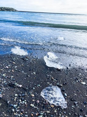 The Diamond Beach with Ice Cubes on Black Sand, near the Jokulsarlon Glacier Lagoon in Iceland