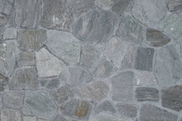 Pedras cinzentas diferentes em uma parede — Fotografia de Stock