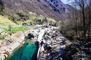 Lavertezzo, Switzerland, 10. April 2022: The View to the Village, Rocks and clear Verzasca River in Ticino, Switzerland