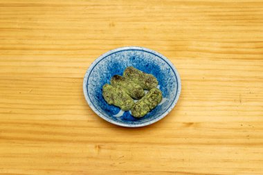 Küçük mavi bir kase üzerinde kibrit çayla yer mantarı çikolataları