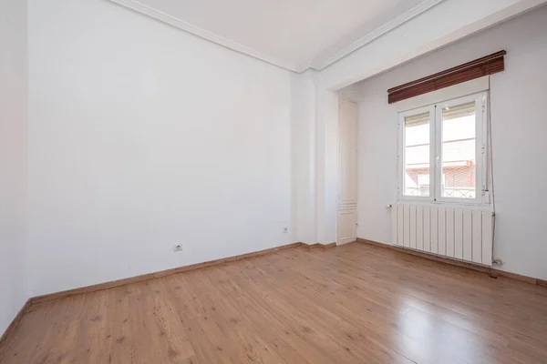Empty bedroom with aluminum window and chestnut flooring