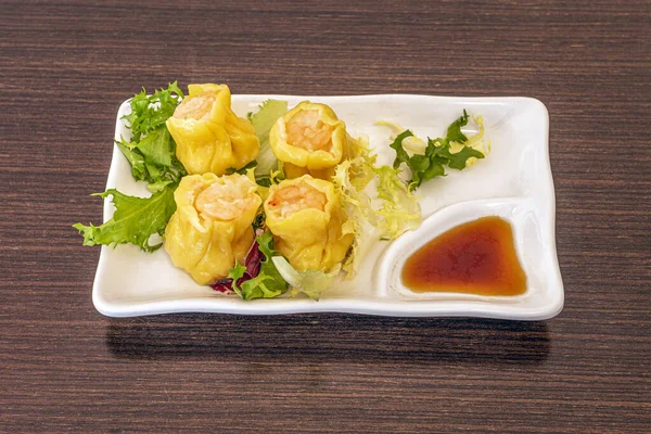 Siomay is an Indonesian dish consisting of a steamed fish dumpling with vegetables served in peanut sauce. It is considered a light meal that is a type of Chinese Dim sum