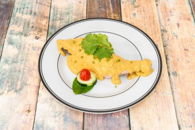 Yassa is a spicy marinated dish made with poultry or fish. It is native to Senegal, but has become popular throughout West Africa.