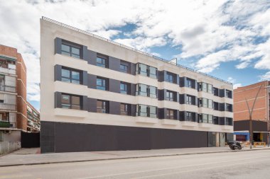 Main facade of the residential apartment building at a street junction