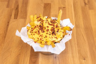 Chips with plenty of cheddar cheese and fried ham tacos