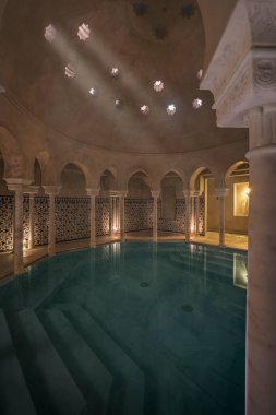 Hot salty water bath with marble column and tumido arches in an Arab bath