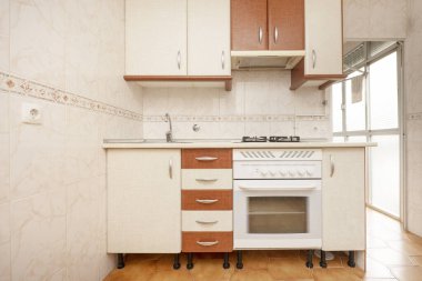 Kitchen with white and wood-colored cabinets with white appliances