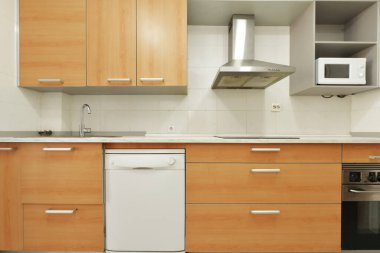 Modern kitchen with large cabinets with drawers in cherry color combined with gray color