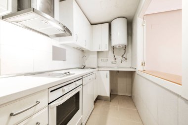 White kitchen with white appliances and window open to the dining room