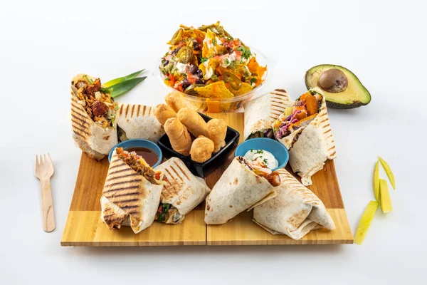 Set Latin American food with tequeos, nachos with guacamole and assorted beans and burritos